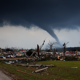 Land with debris, fallen trees from a tornado or storm