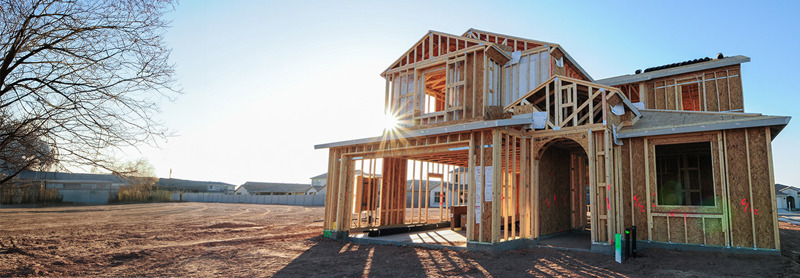 Wood frame home under construction in a housing development